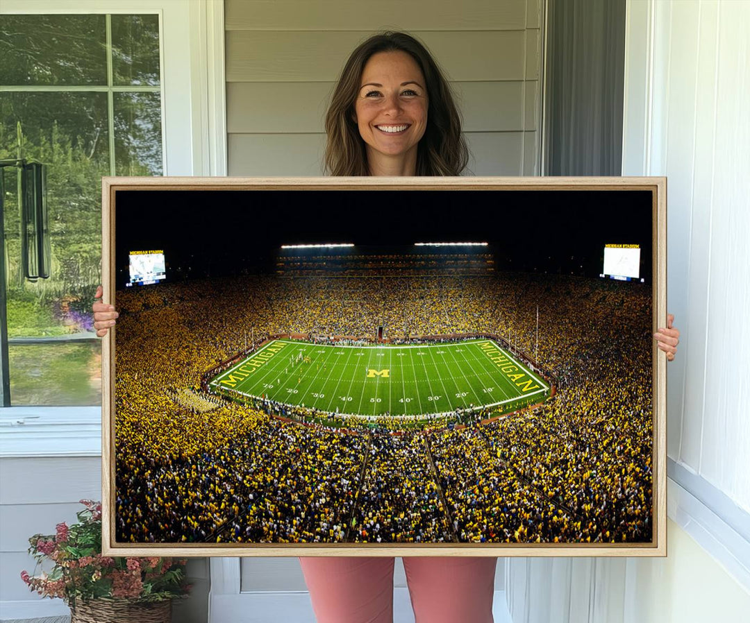 Aerial view of Michigan Stadium night game, ideal for Michigan Wolverines Football Team displayed on a triple canvas wall art.