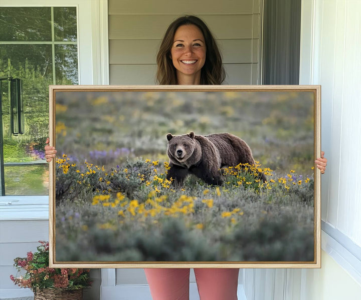 The "Queen of the Tetons" is a stunning canvas wall art print featuring Grizzly 399 walking through a field of yellow and purple flowers, showcasing the gallery-quality finish.