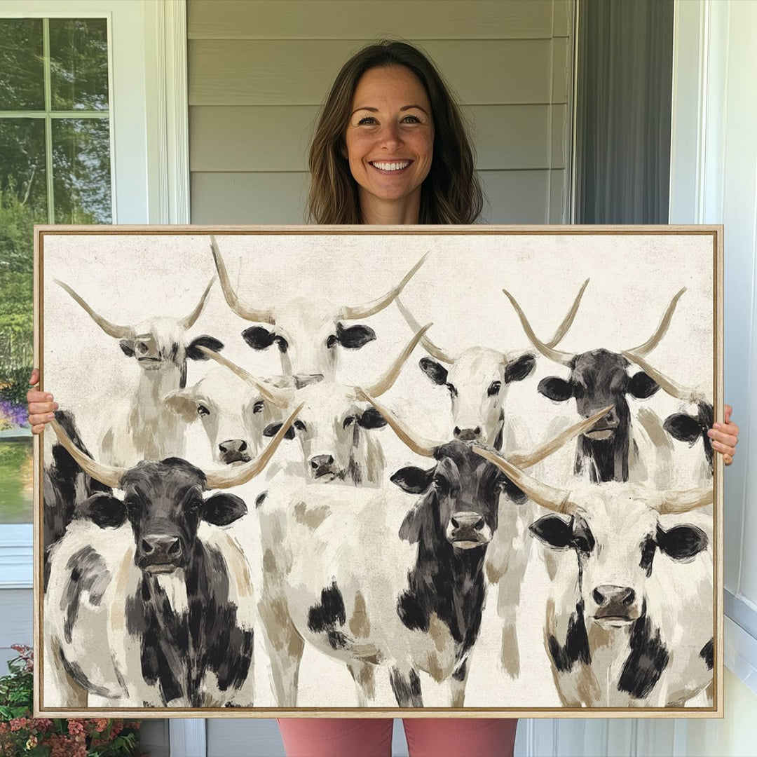 Canvas print titled Longhorn Texas Cow Drawing, depicting longhorn cattle with black and white markings, made in the USA, displayed on the wall.