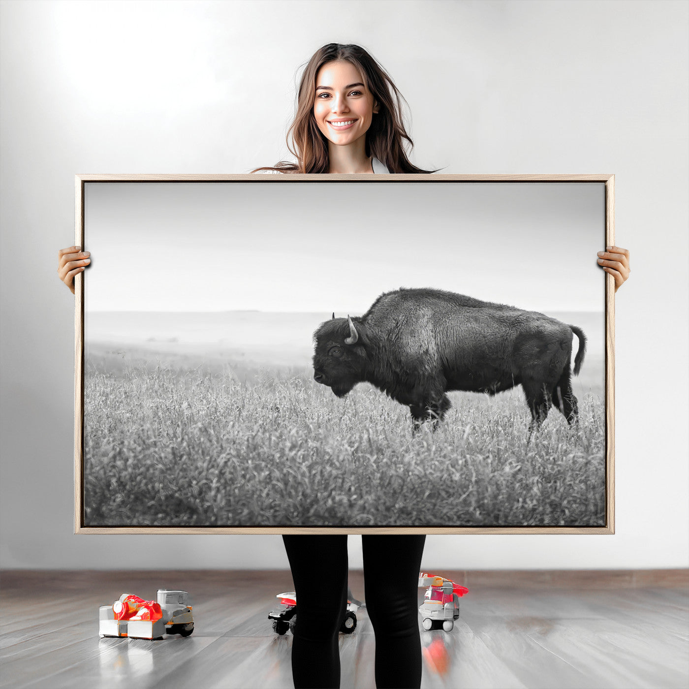 A black and white photograph of a majestic bison standing in a vast grassy prairie, evoking a sense of wilderness and strength.