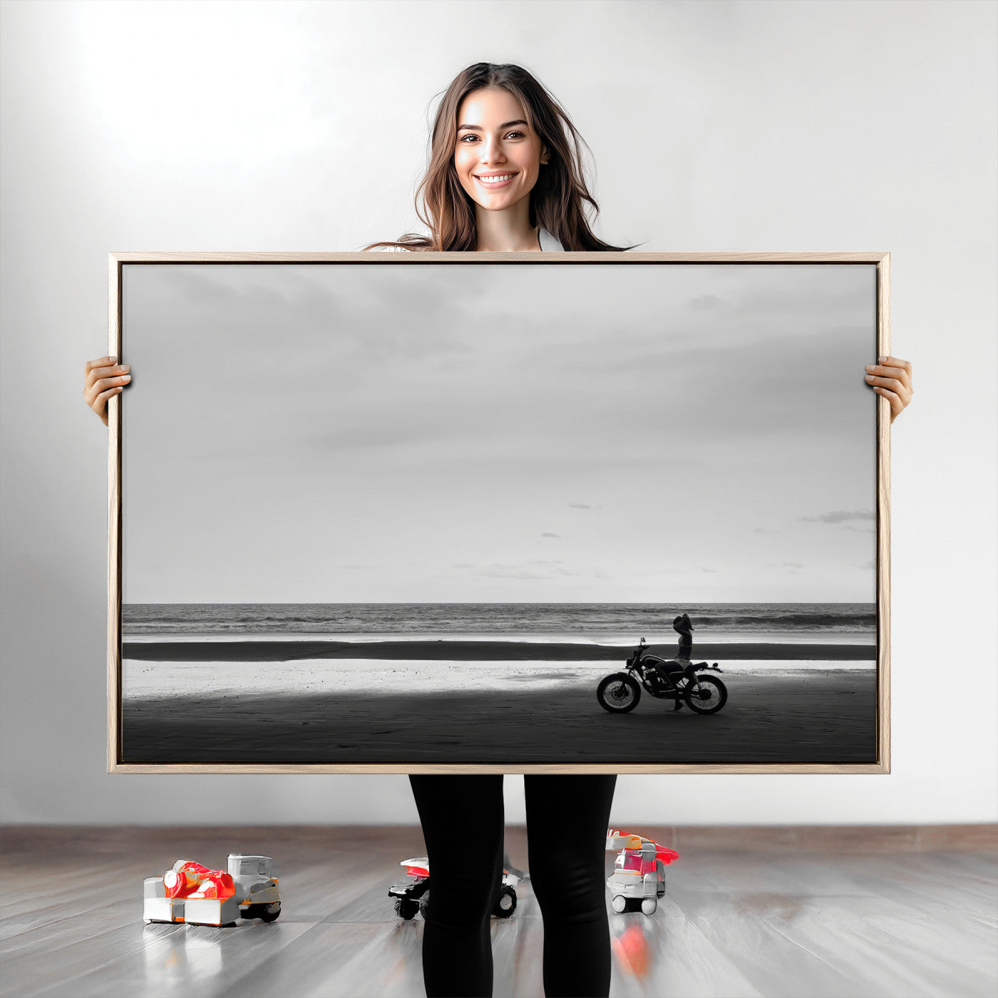 A motorcyclist on a vast beach, gazing at the ocean, capturing a moody and tranquil coastal adventure in black and white.