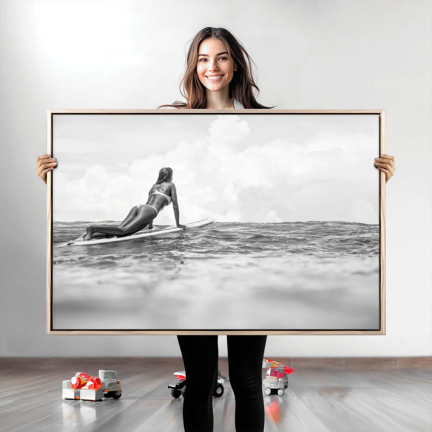 A black and white ocean scene featuring a surfer girl waiting on her board, gazing at the horizon, capturing a tranquil and adventurous coastal moment.