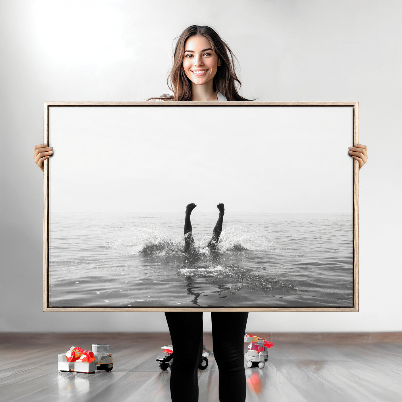 A black and white minimalist water scene capturing a playful splash as a swimmer dives upside down, creating a carefree and artistic aquatic aesthetic.