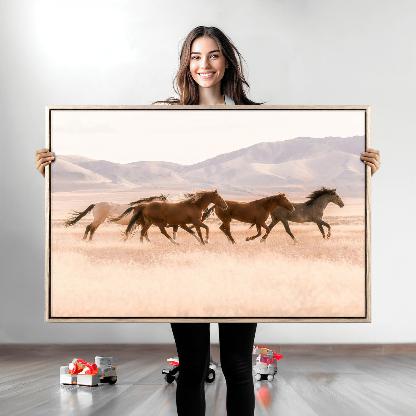 A herd of wild horses galloping through a sunlit desert plain with mountains in the background, perfect for rustic or western-themed wall decor.