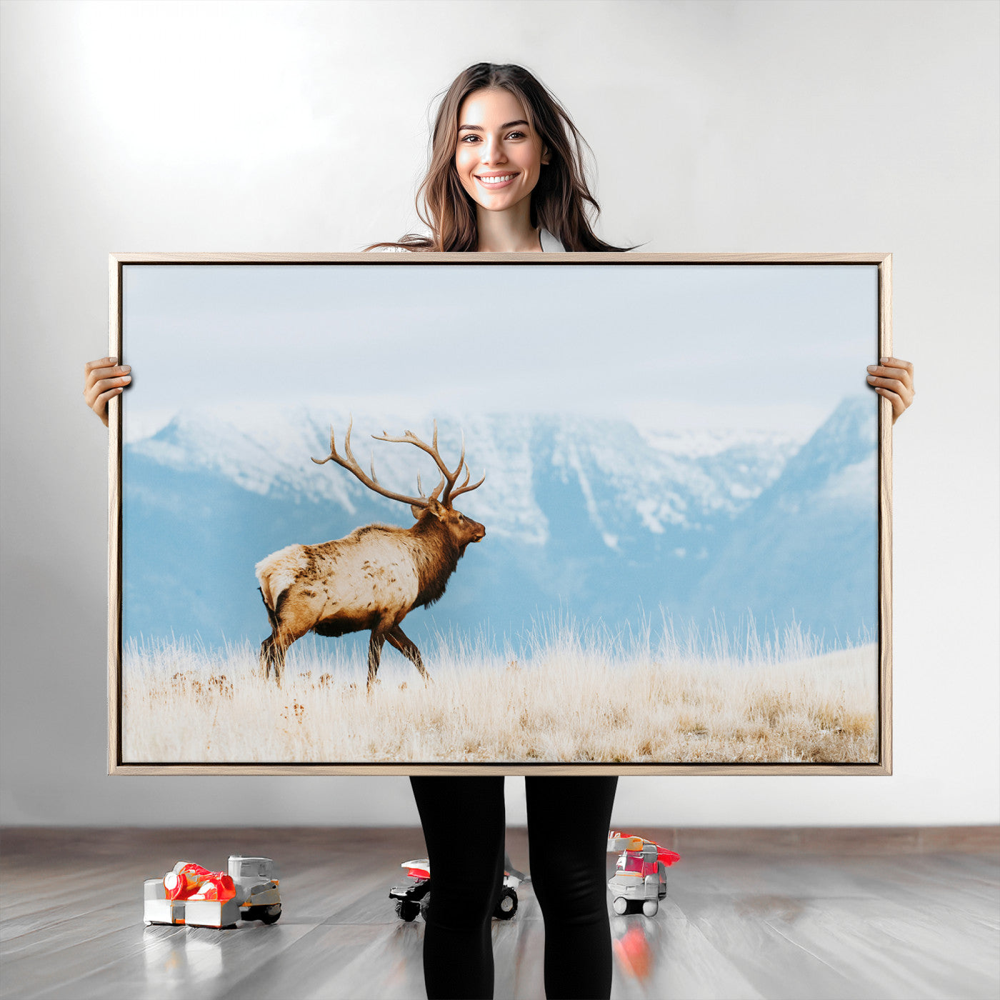 Majestic elk with antlers walking on golden grass, snowy mountains behind, perfect for rustic lodge or Scandinavian decor.