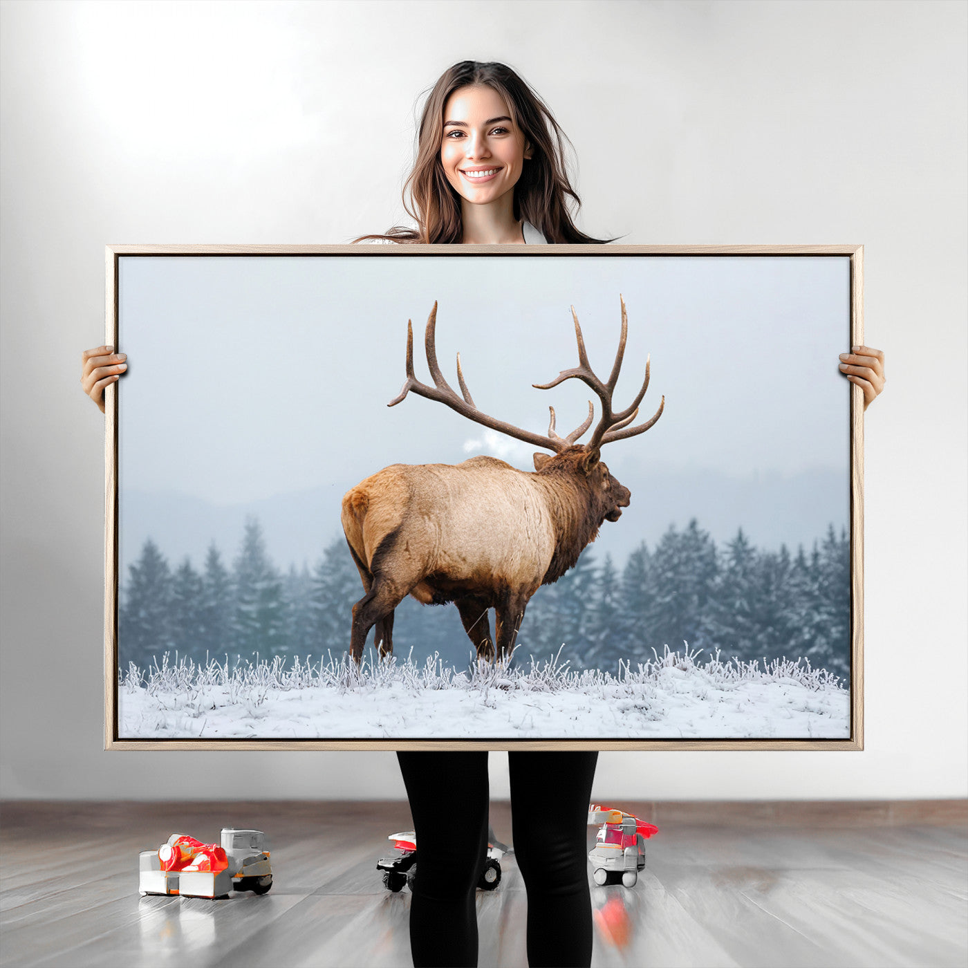 Large elk standing in a snowy field with pine trees in the background, ideal for rustic cabin or lodge-style wall decor.