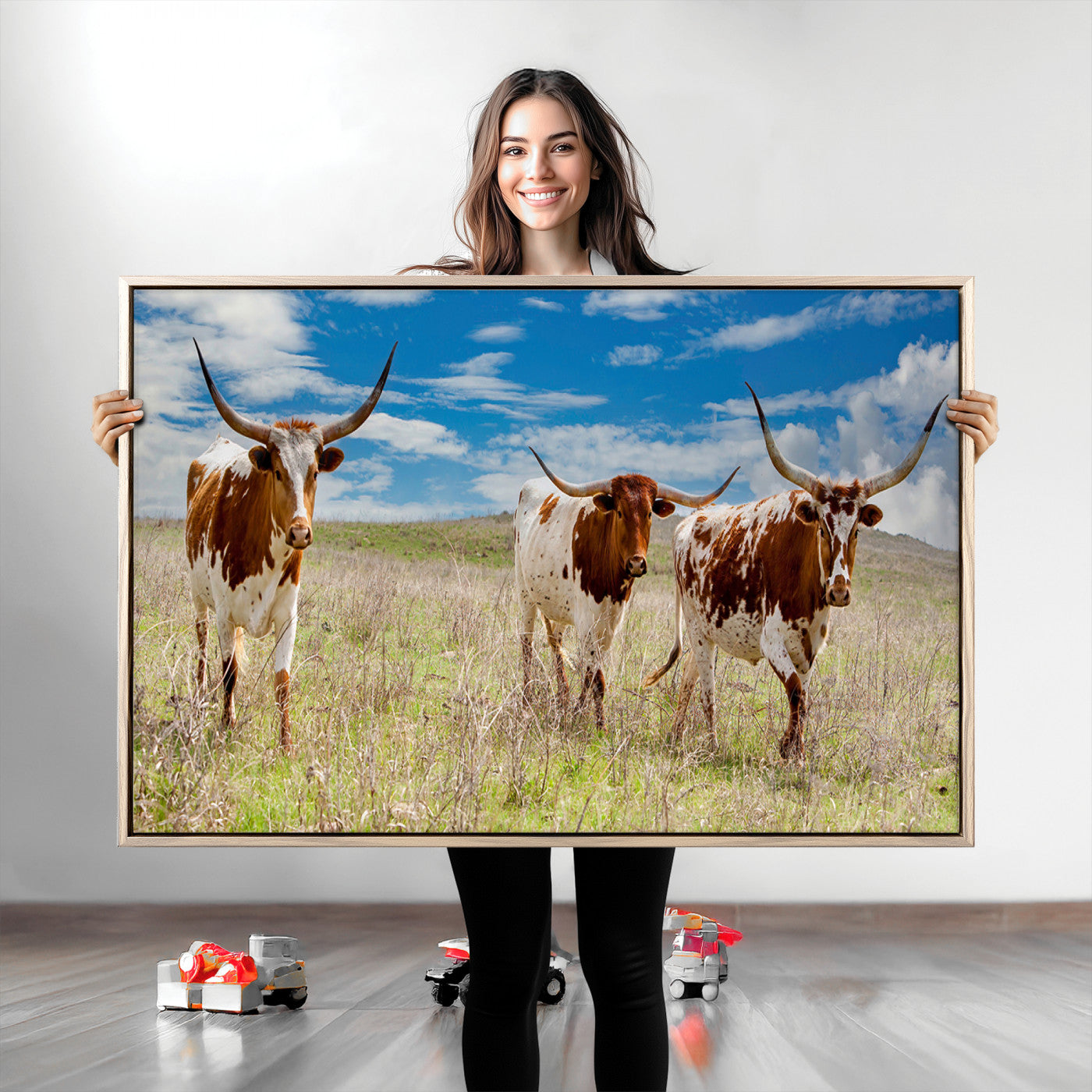 Three Texas longhorn cattle standing in dry grass under a bright blue sky, ideal for farmhouse or western rustic home decor.