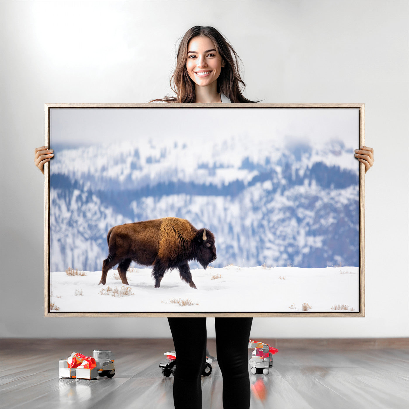 A lone bison walks across snowy ground with blue-toned mountain range behind, ideal for rustic or western farmhouse interiors.