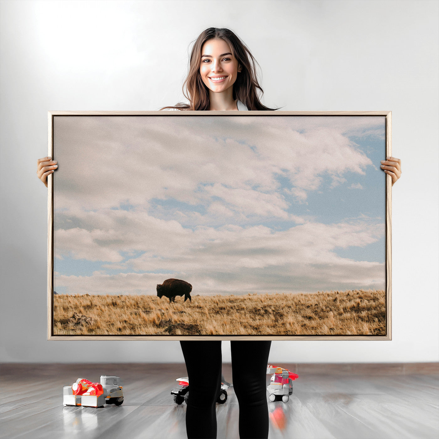 A solitary bison walking across a golden prairie under a vast, cloud-filled sky, evoking a peaceful, rustic western landscape for home decor.