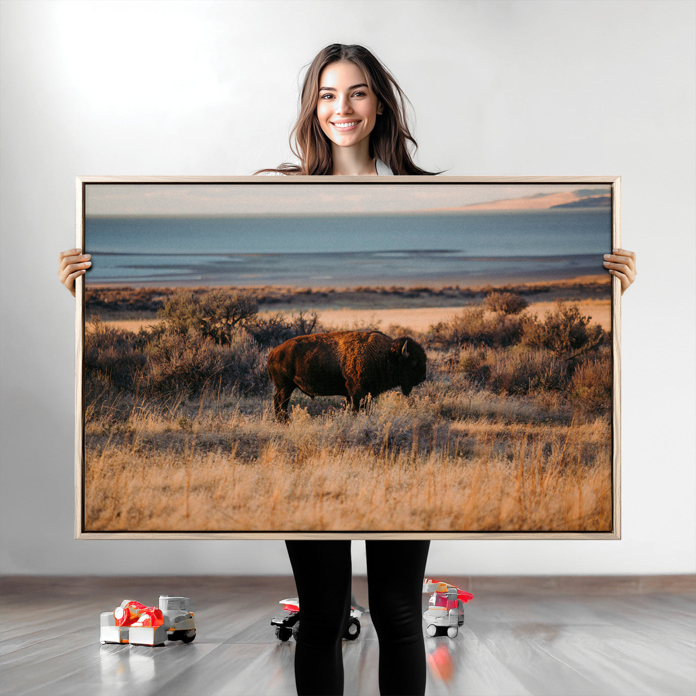 A lone bison grazing in golden prairie grass at sunset, with warm earthy tones and a distant lake view, perfect for rustic and western decor.