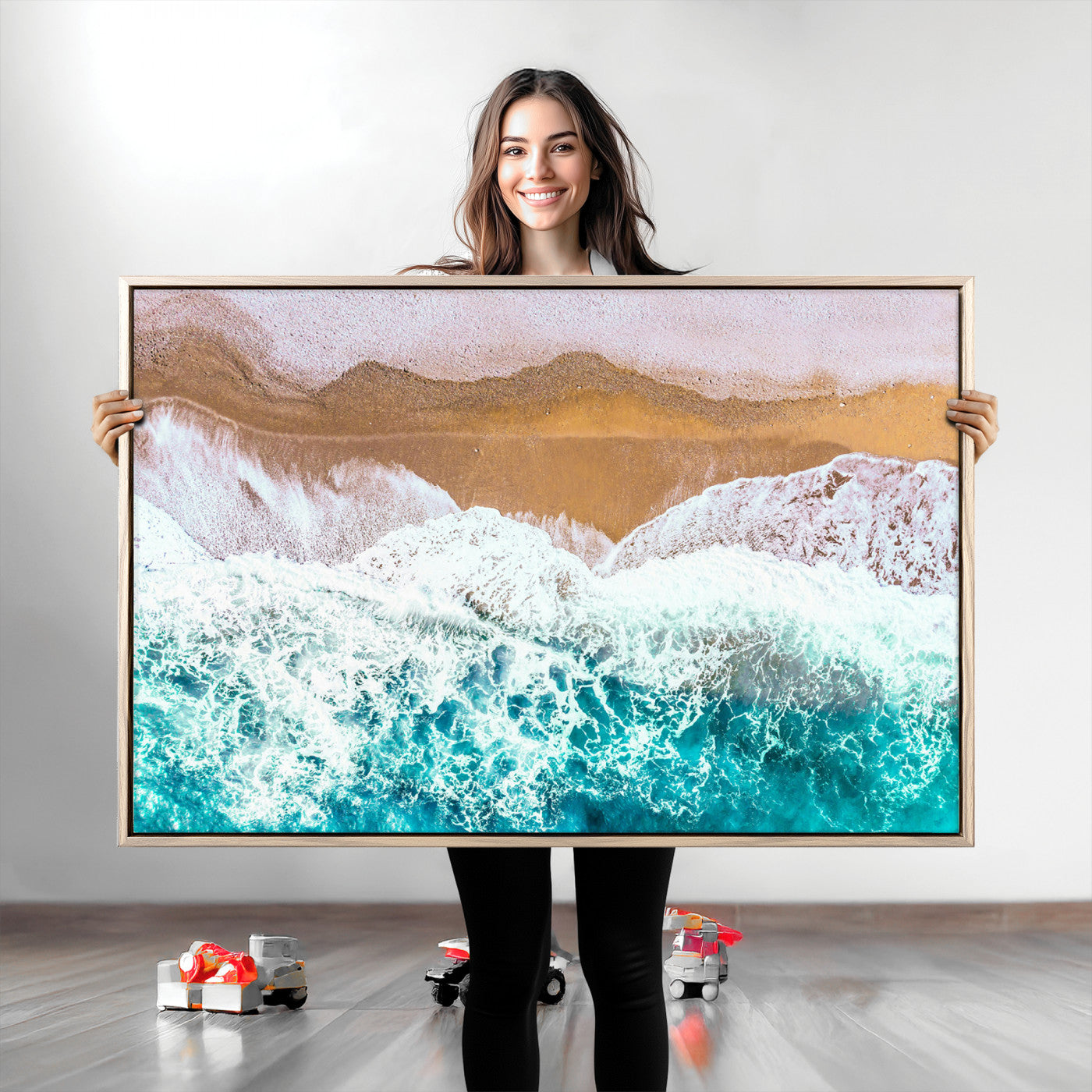 Aerial view of ocean waves crashing onto a sandy beach, with turquoise water and foamy white surf, creating a serene coastal aesthetic for home decor.