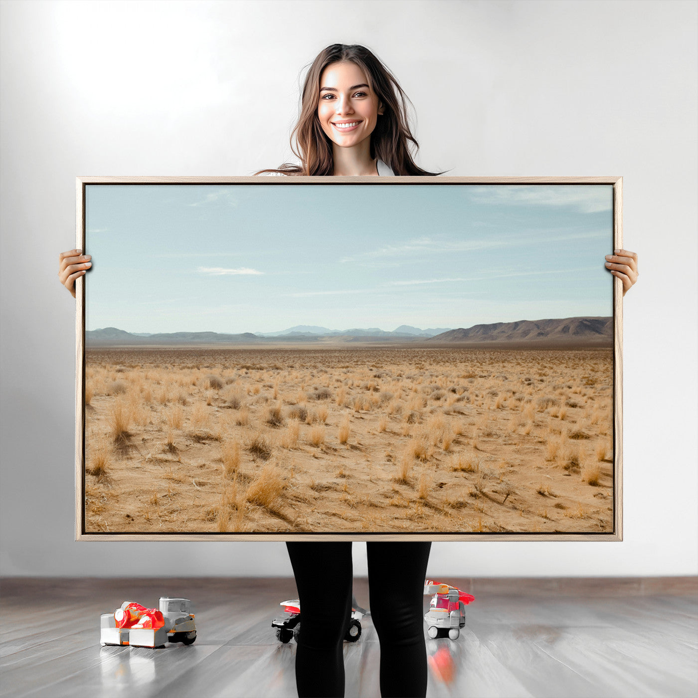 Expansive desert landscape with scattered dry grass and distant mountain range under a pale blue sky – Wall Art Canvas Print.