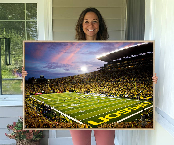 This gallery-quality canvas print features a depiction of the OREGON field filled with fans at sunset, capturing the essence of the University of Oregon Ducks Autzen Stadium.