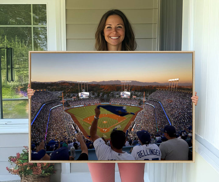 A triple canvas wall art captures the scene at Dodger Stadium, with fans cheering as the sun sets and a flag waving on the field.