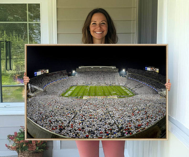 The triple canvas wall art depicts Beaver Stadiums vibrant atmosphere during a night game from the end zone.