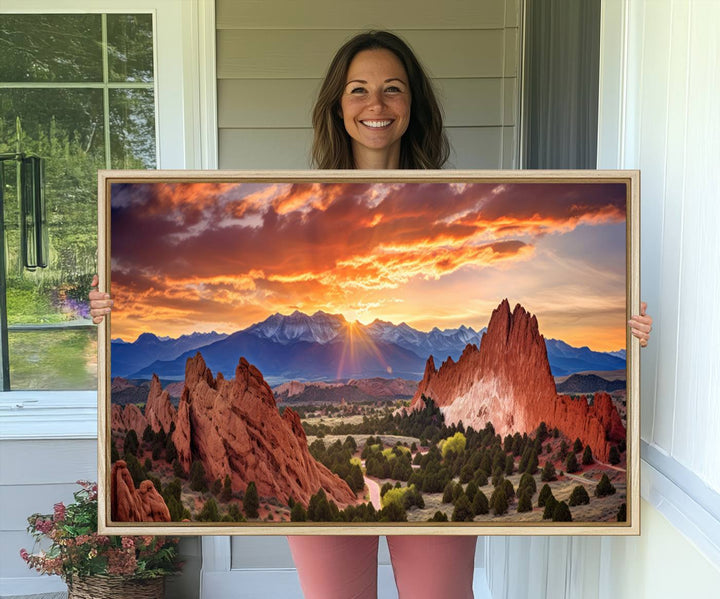 A vibrant sunset over the Rocky Mountains with red rocks.