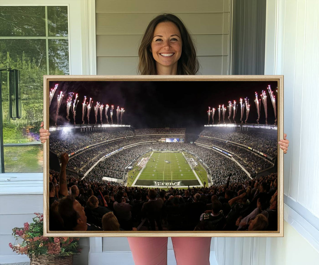 The wall art of Eagles Field Stadium showcases nighttime fireworks over a full stadium.