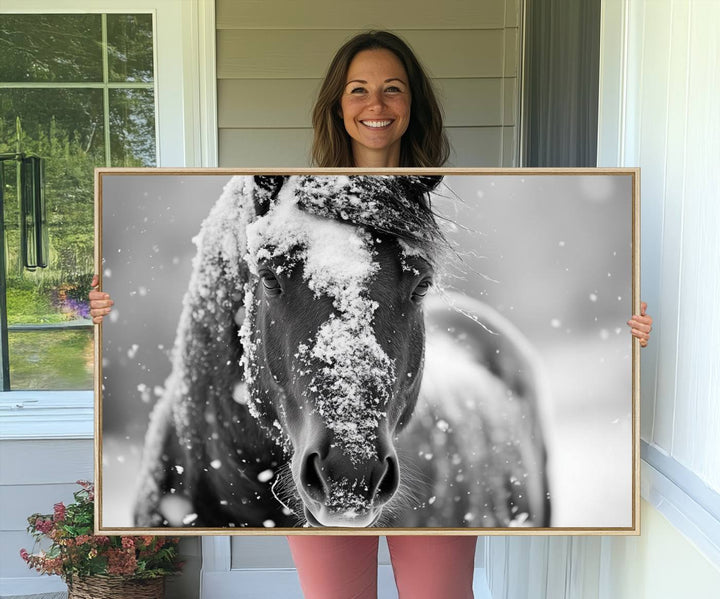 The Black and White Horse Winter Wall Art features a majestic horse with snow-covered hair set against a serene winter backdrop.