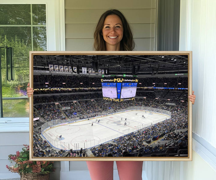 A large Enterprise Center canvas of a crowded hockey arena hangs prominently.