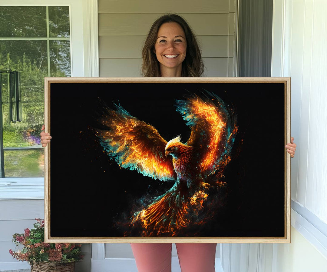 The Fiery Phoenix Canvas Print, showcasing a majestic bird with fiery wings against a black background, makes for the perfect bold decor in your living room.