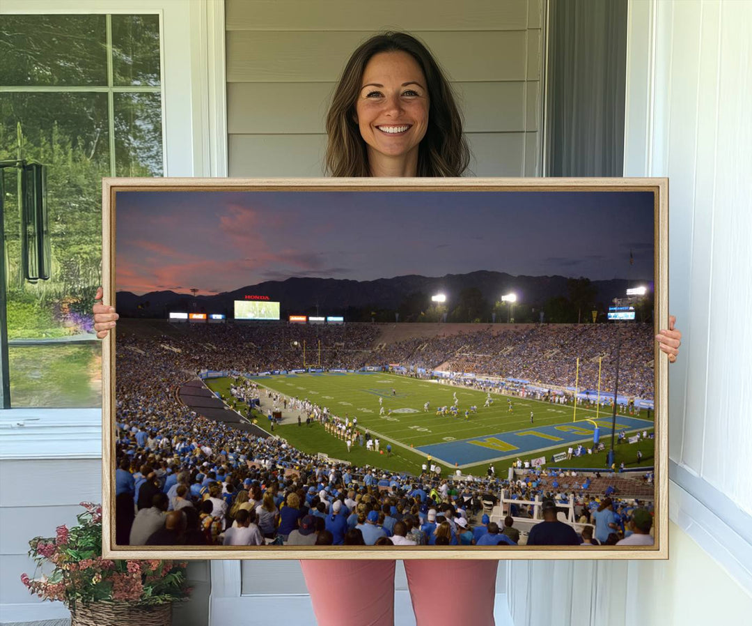 Admire the stunning wall art canvas depicting a UCLA Bruins game with a sunset over the Pasadena Rose Bowl Stadium.