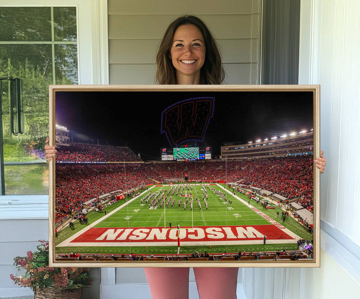 A premium canvas print captures a vibrant scene of Camp Randall Stadium featuring a lively football game with cheering fans and the energetic movements of the band.