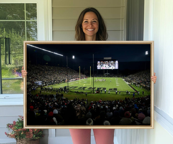 A Purdue Boilermakers canvas print beautifully showcases Ross–Ade Stadium in West Lafayette, vibrant with fans and a large screen display.