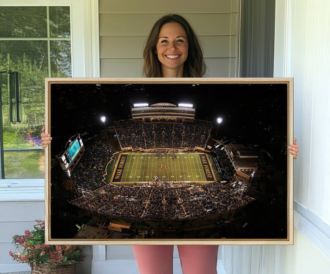 Canvas wall art displays an aerial view of Wake Forest Demon Deacons stadium at night.