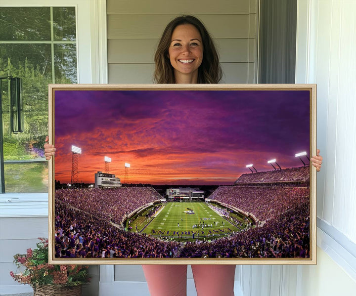 A sunset over Dowdy-Ficklen Stadium, Greenville, captured on museum quality canvas with vibrant purple and orange skies.