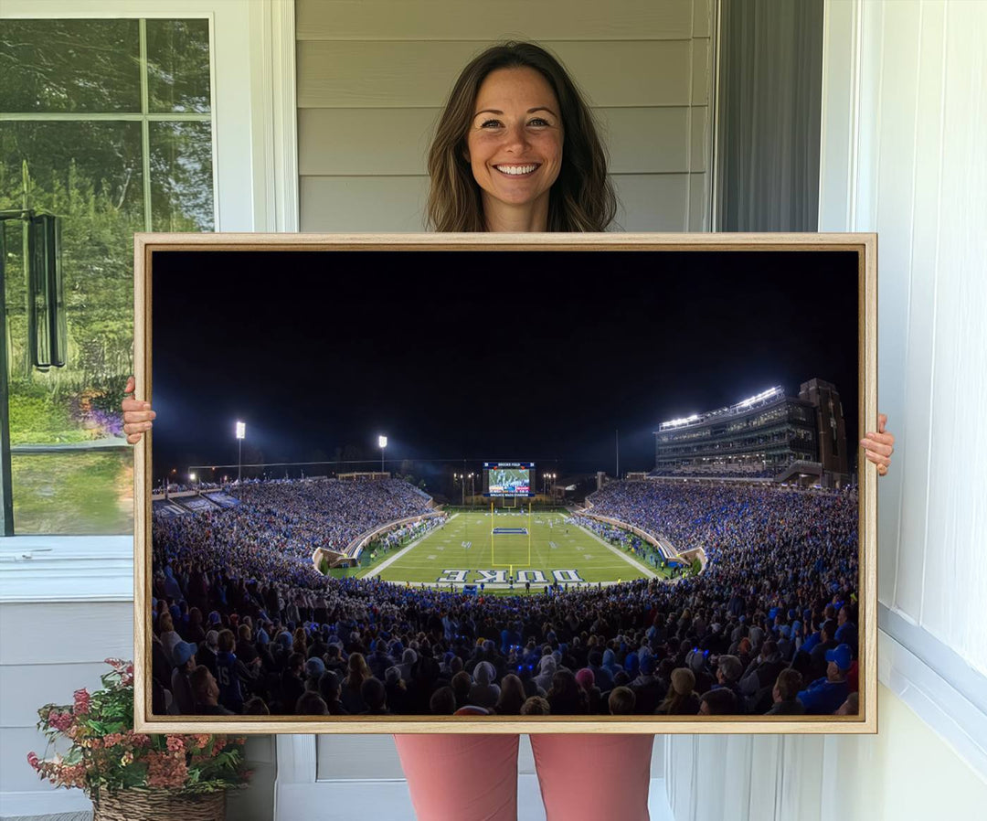 Under bright lights at night, the Duke Blue Devils Football Team Durham canvas wall art print is prominently displayed.