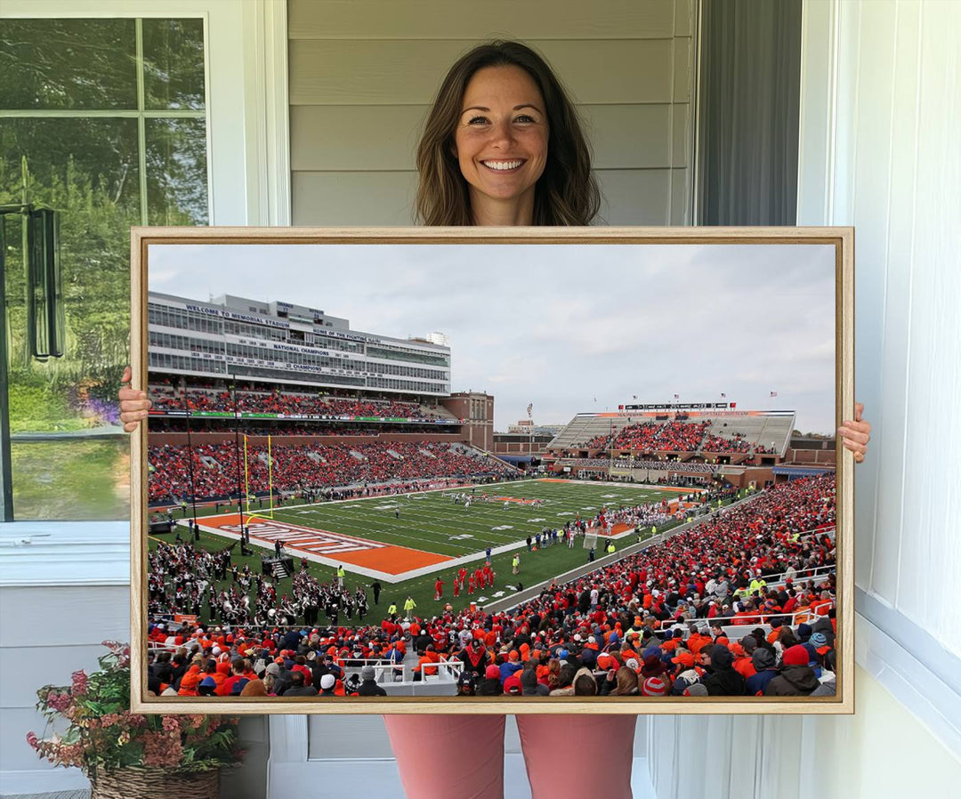 A University of Illinois Fighting Illini wall art canvas hangs on the wall, depicting a packed stadium.