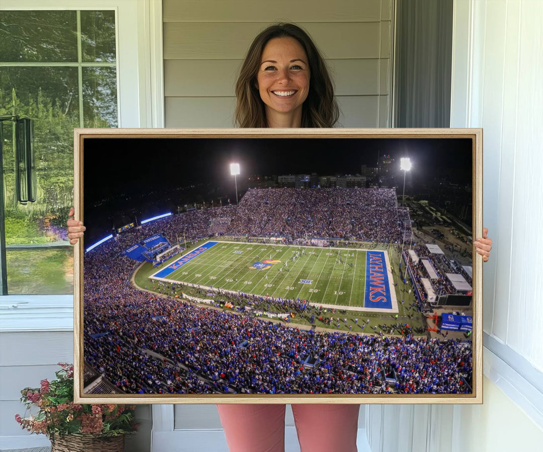 A canvas depicting an aerial view of the University of Kansas Memorial Stadium, showcasing bright lights and a lush green field at night.