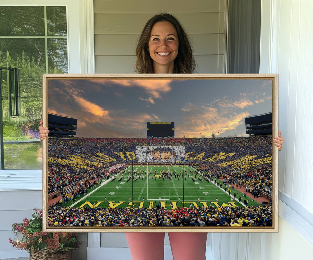 A giant image resembling Michigan Wolverines Wall Art depicts a football field beneath a dramatic sky.