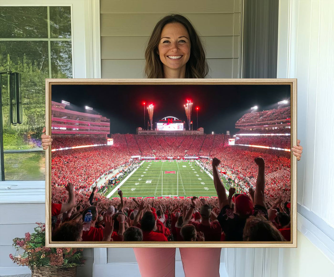 A vibrant canvas print of the Lincoln Memorial Stadium at night with fireworks, featuring the University of Nebraska Cornhuskers Football.