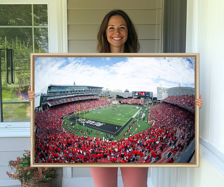 The wall showcases a Nippert Stadium canvas print of the Cincinnati Bearcats.