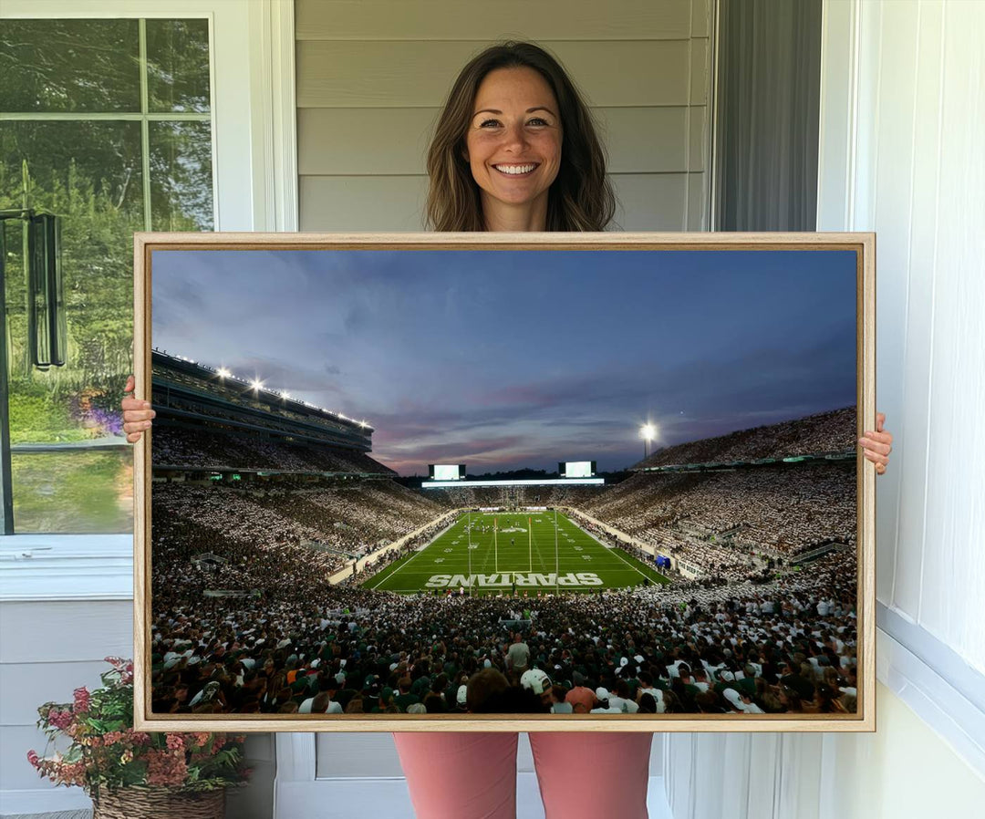 Wall art featuring a stadium at dusk with full stands—ideal for the Michigan State Spartans Football Team Canvas Print.