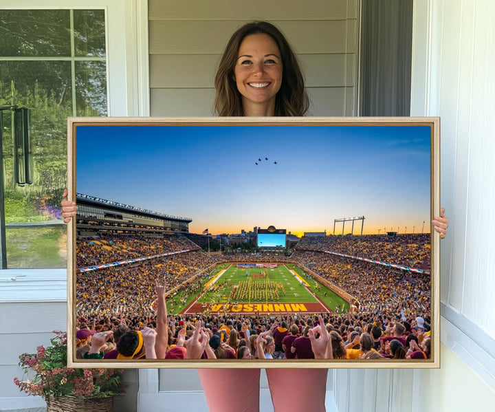 Canvas wall art featuring the University of Minnesota Football Team print, showcasing Huntington Bank Stadium at sunset with jets overhead.