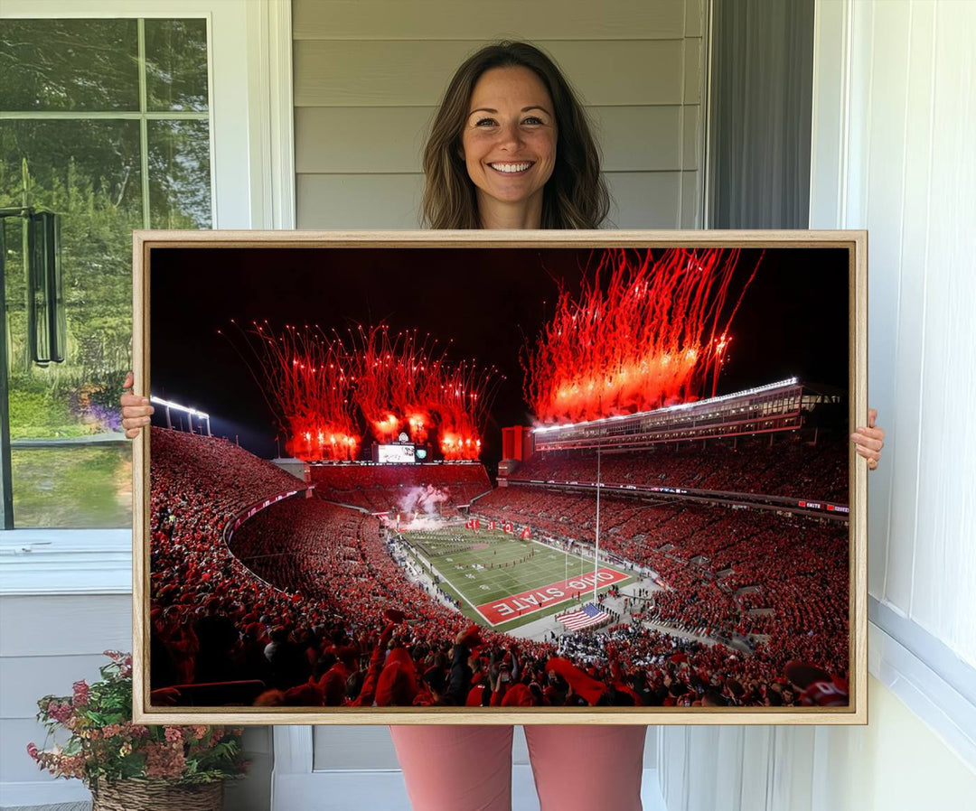 A vibrant red canvas art of a packed Ohio State Buckeyes stadium at night with fireworks.