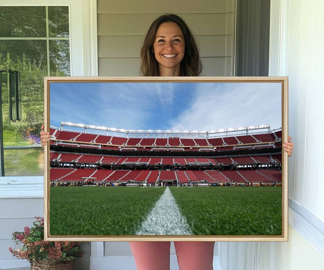 A canvas print of the University of Tulsa Golden Hurricane showcases H.A. Chapman Stadiums football field and red seats against a backdrop of a blue sky.