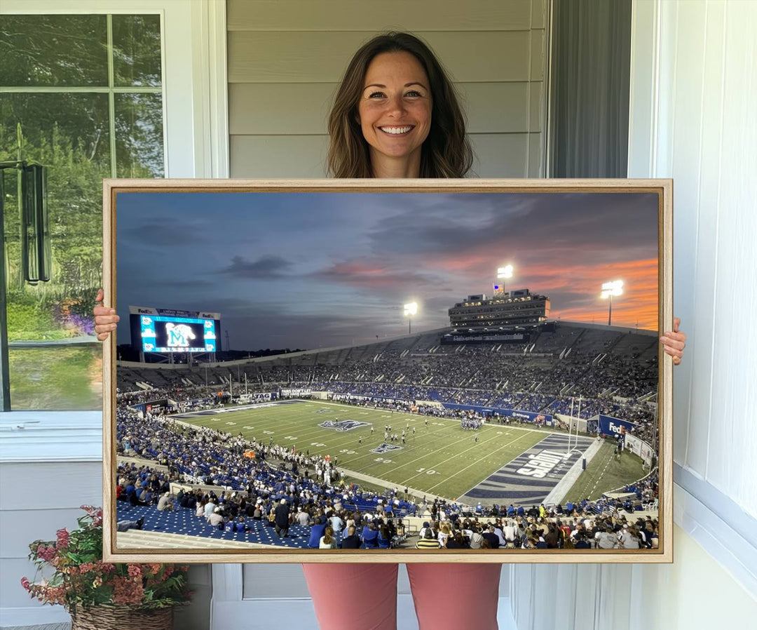 A Memphis Tigers football canvas print of Simmons Bank Liberty Stadium at sunset enhances the living room.