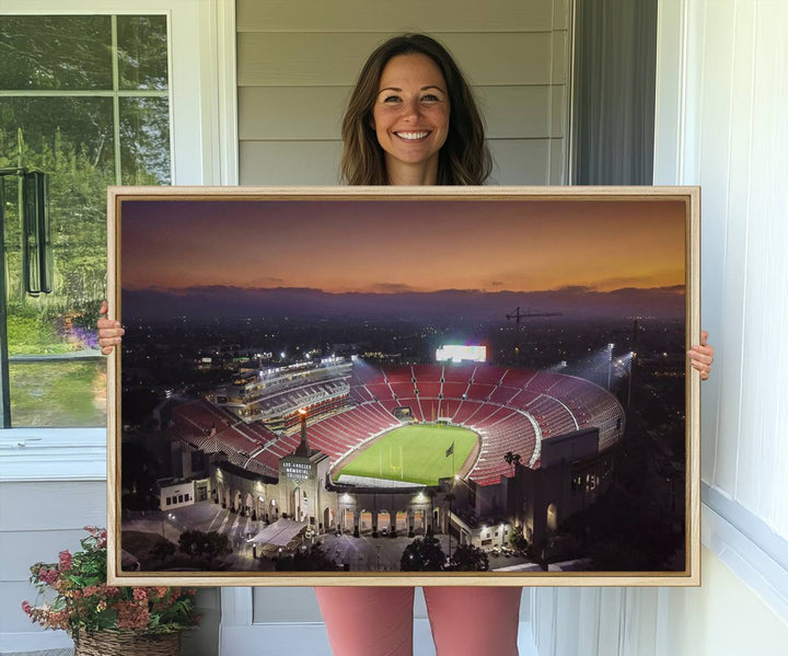 The USC Trojans Stadium canvas captures Memorial Coliseum at twilight, showcasing red seats and a green field beneath an orange sky.