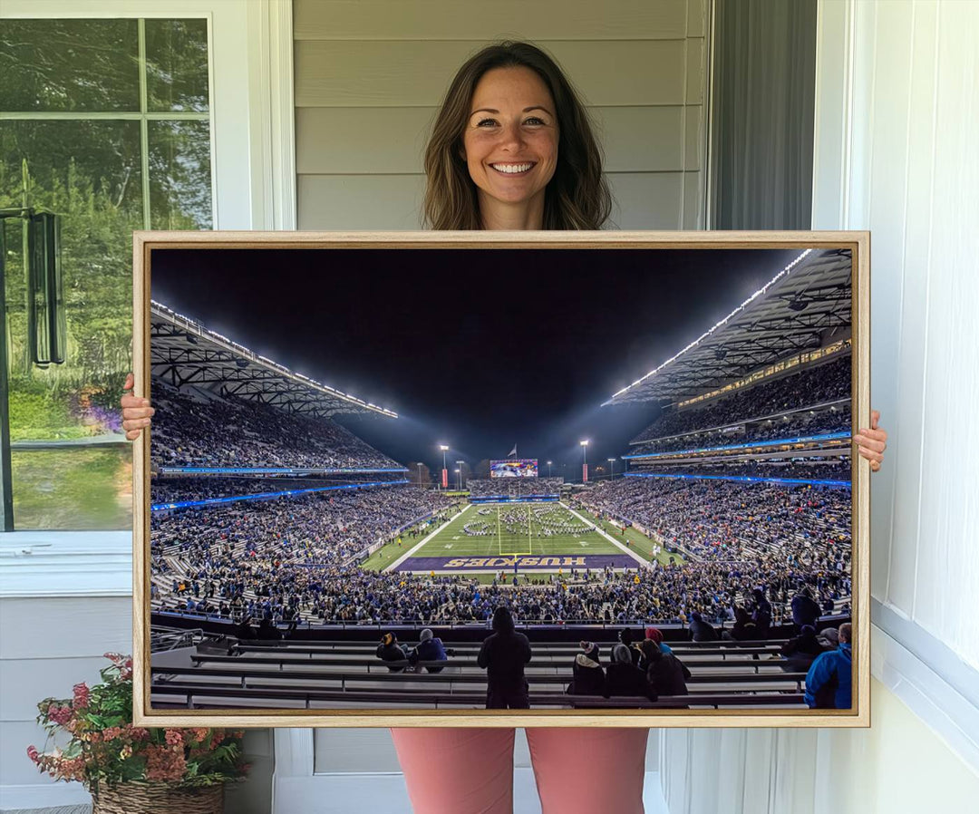 A canvas print titled The University of Washington Huskies Football depicts a packed Husky Stadium at night, as seen from the stands.