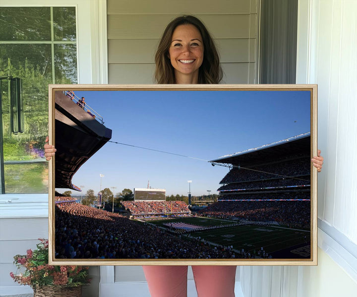 The University of Washington Huskies wall art print depicts Husky Stadium coming alive with fans as flags flutter.