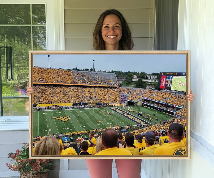 A Puskar Stadium canvas print decorates the modern living room shelf.