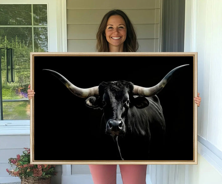 A captivating close-up canvas print of a Texas Black Longhorn with impressive curved horns set against a dark backdrop, ideal as a standout piece in your collection of Longhorn Cow Wall Art.