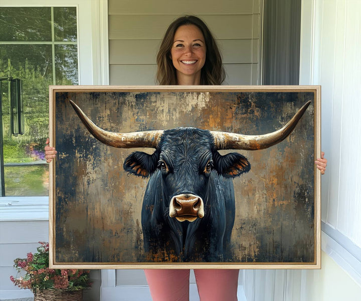 The Texas Western Wall Art Canvas Print showcases a Longhorn Bull set against an abstract brown and gray backdrop, making it perfect for rustic decor.