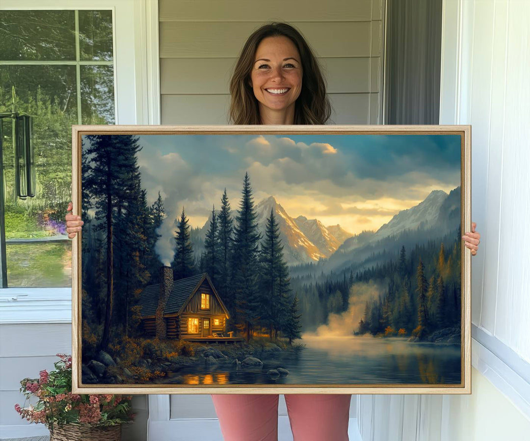 Serene sunset lake wall art: a cozy mountain cabin with lights, framed by pine trees and set against a moody sky. Ideal for adding rustic lodge charm to your space.