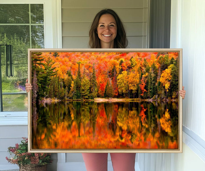 Autumn Forest Reflection Wall Art: a vibrant triptych canvas featuring fall foliage with red, orange, and yellow leaves over a calm lake.