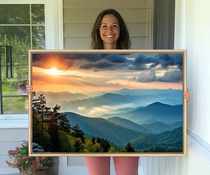 The wall art, titled Sunrise Over Mountain Range, is a canvas print that beautifully depicts layers of hills, scattered trees, and a partly cloudy sky.