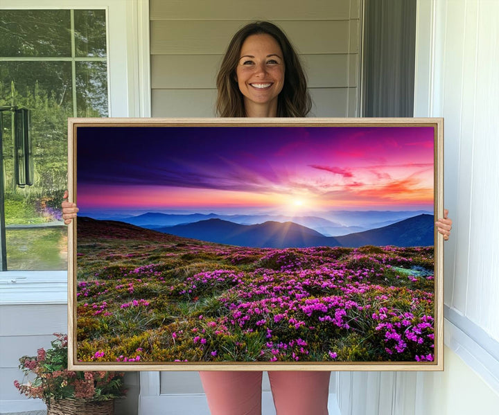 A 3-panel landscape photography canvas of a sunset over mountain meadows with purple wildflowers decorates the wall.